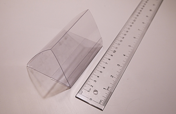 [clear plastic packaging folded into triangle shape]